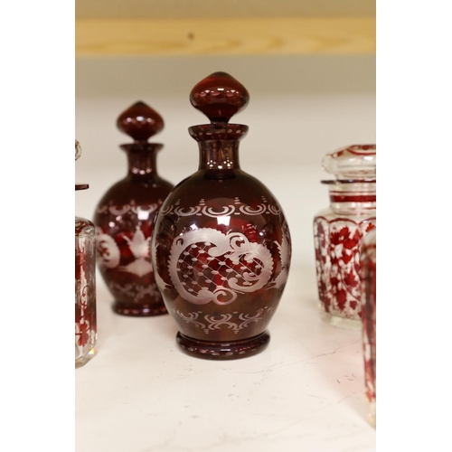 1354 - A pair of 19th century wheel engraved ruby glass decanters with stoppers, and seven ruby stained gla... 