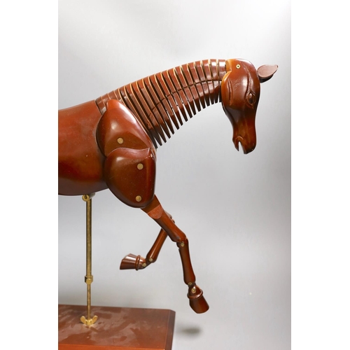 1361 - A modern artist's wooden articulated model of a horse, on stand,approx 51 cms wide x 46cms high,... 