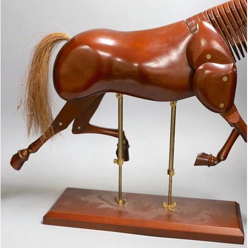 1361 - A modern artist's wooden articulated model of a horse, on stand,approx 51 cms wide x 46cms high,... 