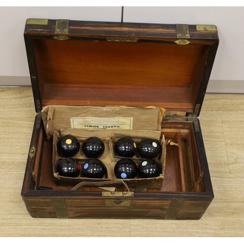 1376 - A boxed set of eight Banda carpet bowls, in a Victorian coromandel writing slope (a/f), 35cm wide... 