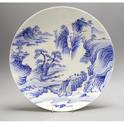 1389 - A Japanese blue and white landscape porcelain charger, marked to base, 38cm diameter