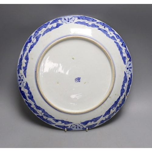 1389 - A Japanese blue and white landscape porcelain charger, marked to base, 38cm diameter