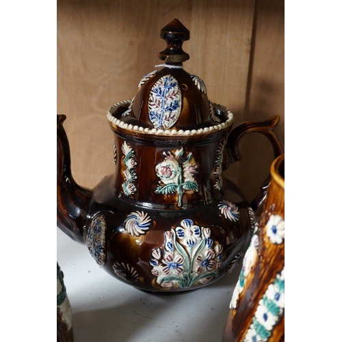 1390 - A Victorian Measham pottery bargeware teapot and three graduated jugs (4)