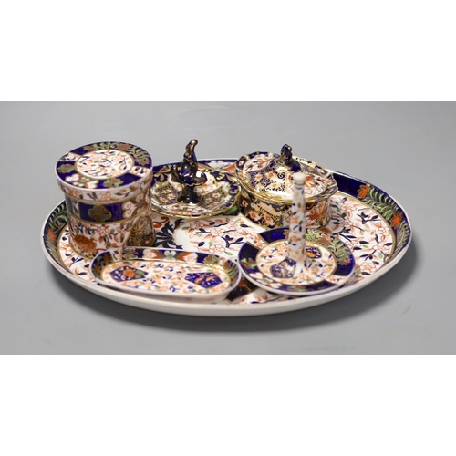 1403 - A collection of Royal Crown Derby and Crown Derby wares, including a cabaret tray, two ring stands, ... 