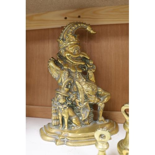 1407 - A graduated set of twelve brass bell weights and a cast brass Punch door stop. 30cm