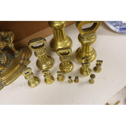 1407 - A graduated set of twelve brass bell weights and a cast brass Punch door stop. 30cm