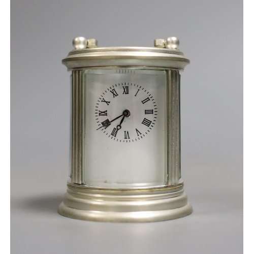 1419 - A circular plated carriage clock with key and a Victoria Cross gent's wristwatch