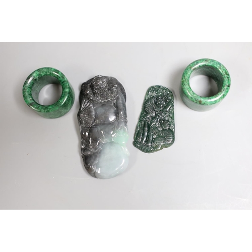 1428 - Two Chinese green hardstone archer's rings, together with a jadeite carving of Zhong Qui and another... 