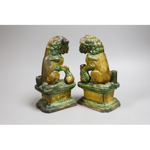 1435 - A pair of Chinese sancai lion dog joss-stick holders, late Ming dynasty,20cm high,