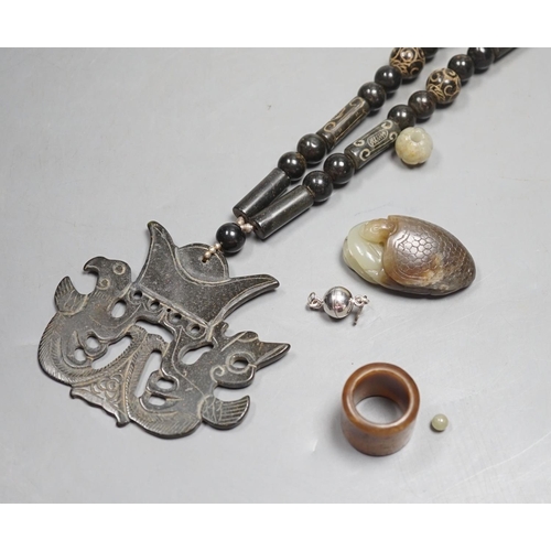 1436 - Kai Yin Lo of Hong Kong, a jade turtle and snake pendant, jade archers ring and two beads, formerly... 