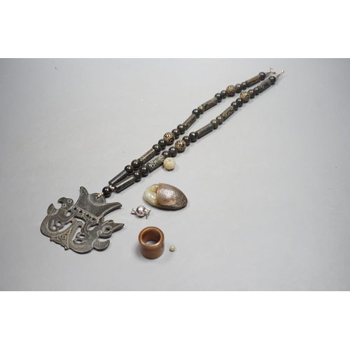 1436 - Kai Yin Lo of Hong Kong, a jade turtle and snake pendant, jade archers ring and two beads, formerly... 