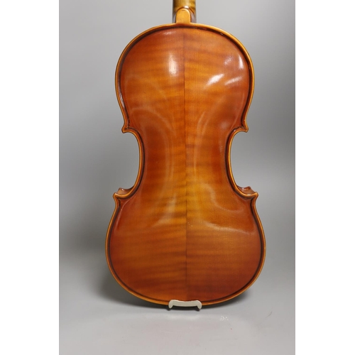 1453 - A cased child's violin and bow with ivorine tip, violin 55cms long,