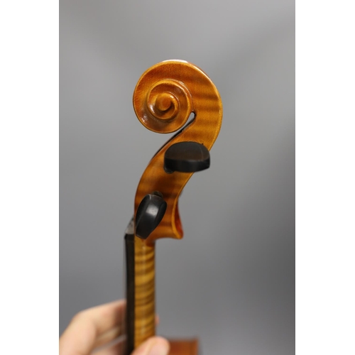 1453 - A cased child's violin and bow with ivorine tip, violin 55cms long,