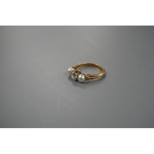 1941 - A yellow metal, cultured pearl and diamond set three stone ring, size L, gross weight 3 grams, the d... 