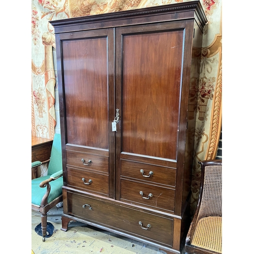 13 - A 1920's mahogany press cupboard with part dummy drawer front over a single drawer, width 120cm, dep... 