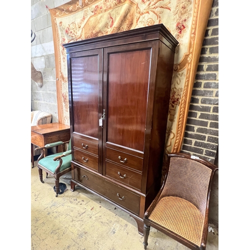 13 - A 1920's mahogany press cupboard with part dummy drawer front over a single drawer, width 120cm, dep... 