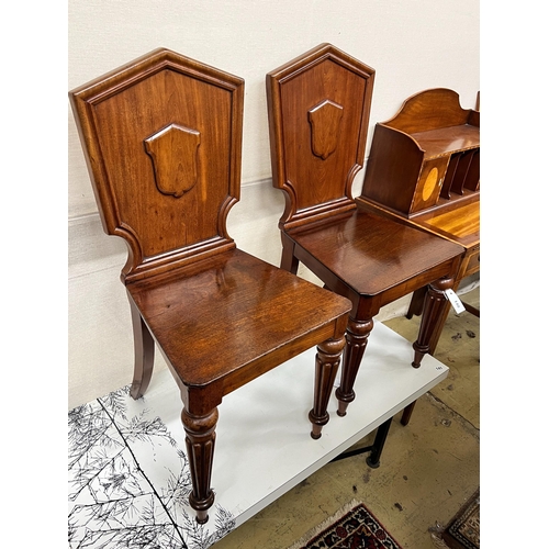 140 - A pair of Victorian mahogany hall chairs