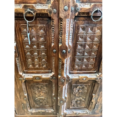 158 - An Eastern carved hardwood two door cabinet, width 119cm, depth 67cm, height 192cm