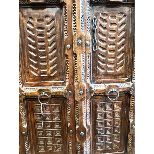 158 - An Eastern carved hardwood two door cabinet, width 119cm, depth 67cm, height 192cm