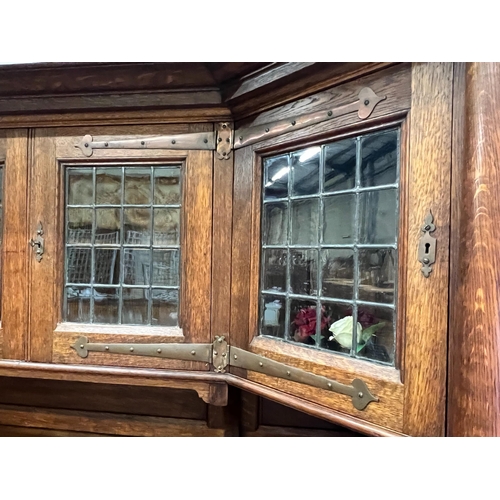 161 - An early 20th century Arts & Crafts copper mounted oak sideboard in the manner of Shapland and Pette... 