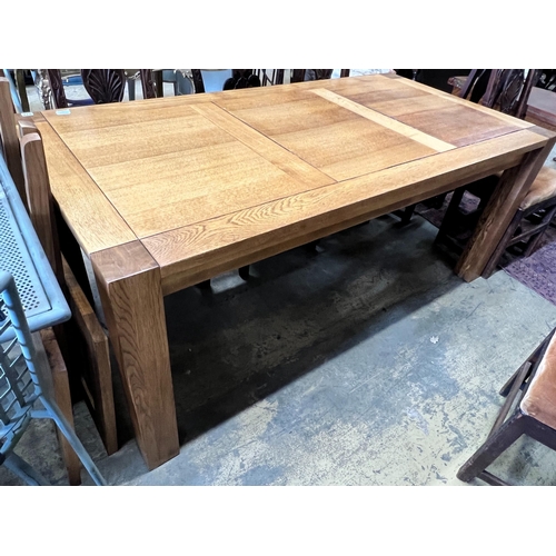 178 - A large contemporary rectangular oak dining table, with removable end leaves, length 280cm extended,... 