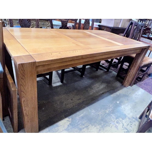 178 - A large contemporary rectangular oak dining table, with removable end leaves, length 280cm extended,... 