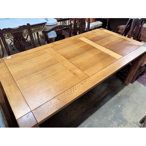 178 - A large contemporary rectangular oak dining table, with removable end leaves, length 280cm extended,... 