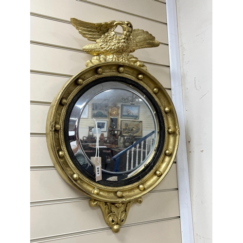 207 - A 19th century Regency style circular wall mirror with eagle surmount, width 46cm, height 70cm... 