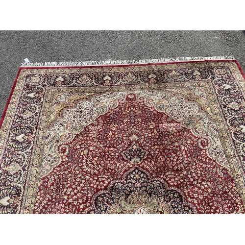 217 - A Kashmiri part silk burgundy ground floral carpet, 330 x 240cm