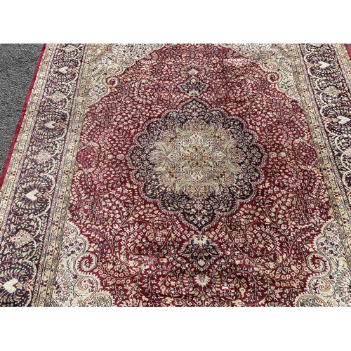 217 - A Kashmiri part silk burgundy ground floral carpet, 330 x 240cm