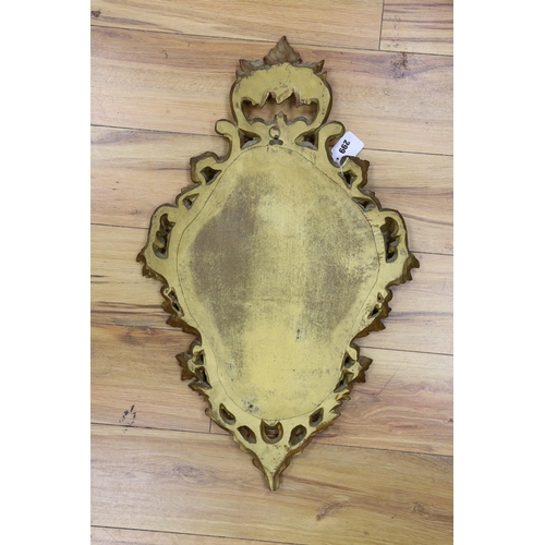 292 - A reproduction gilt framed wall mirror, in the Rococo style, 73cm tall