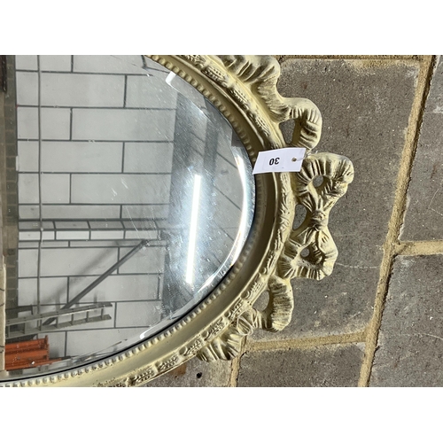 30 - A Victorian style oval painted wall mirror, width 58cm, height 84cm