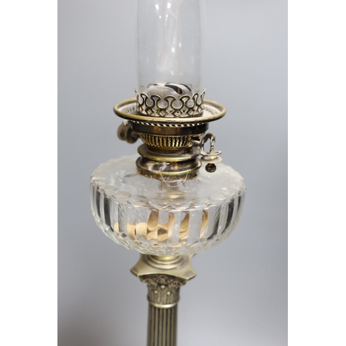 301 - A Victorian silver plated Corinthian column oil lamp, with a glass reservoir