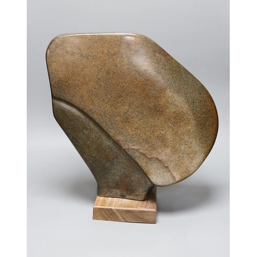 304 - A Zimbabwean carved and polished stone abstract study of a head with a fist, 35cms.