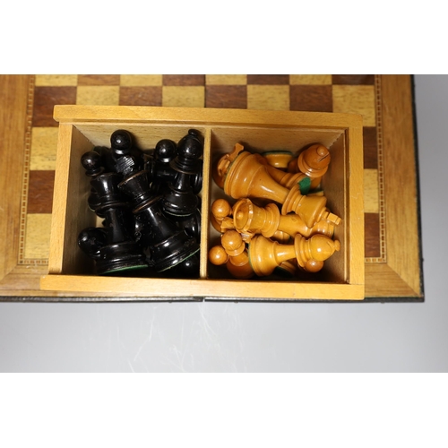 329 - Two complete wood carved cased chess set pieces, king: 8cm and 7.5cm tall, together with a playing b... 