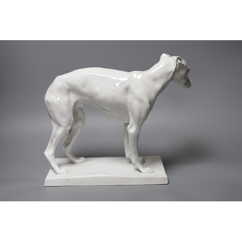 337 - A 20th century German white glazed porcelain model of a whippet, impressed D. Moldenhauer, 31cm wide... 