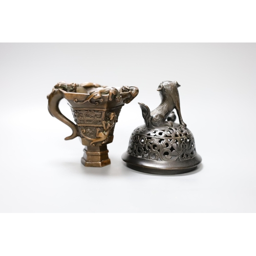 338 - A Chinese bronze handled libation cup, together and a bronze cover with pierced decoration and seate... 