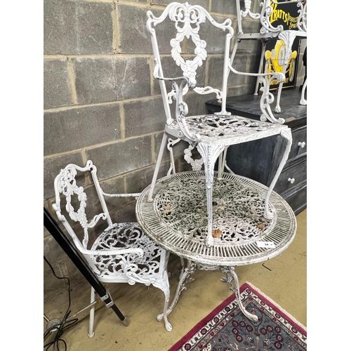 34 - A circular painted aluminium garden table, diameter 80cm, height 70cm together with four elbow chair... 