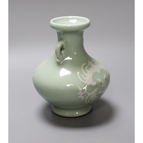 340 - A Chinese celadon two handled vase with slip decoration, 15cm tall