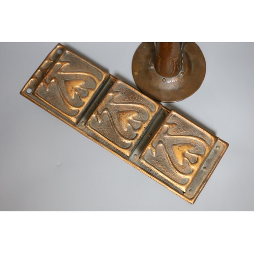 364 - An Arts and Crafts hammered copper candlestick, 18cm tall, and a copper hanging letter rack