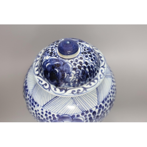 374 - A 19th century Chinese blue and white lidded baluster vase, 28cm tall