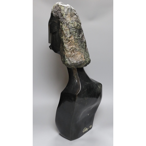 381 - A Zimbabwean carved and polished stone head and upper torso of a woman, 61cms.