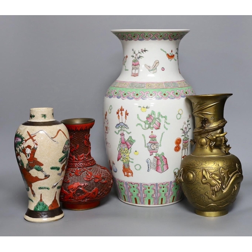 387 - A Chinese crackle glaze warriors vase, a famille rose hundred antiques vase, a cinnabar lacque... 