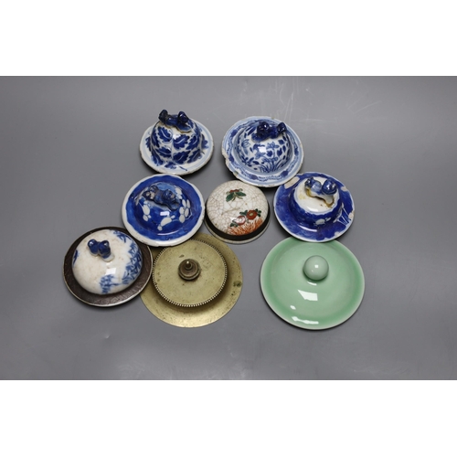 393 - A collection of various Chinese porcelain lids/covers, a clobbered blue and white tea bowl, a brass ... 