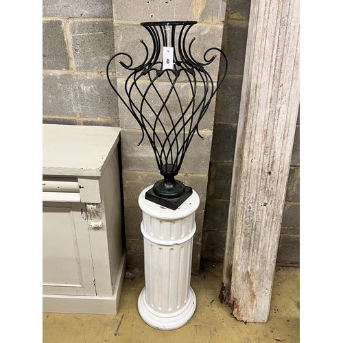 40 - A painted wrought iron vase shaped ornament on painted fluted pedestal, total height 139cm