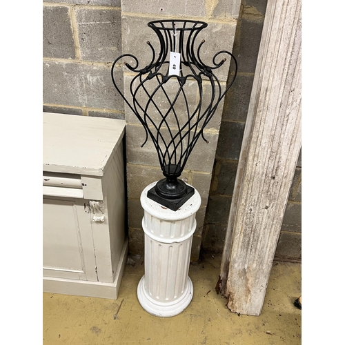 40 - A painted wrought iron vase shaped ornament on painted fluted pedestal, total height 139cm