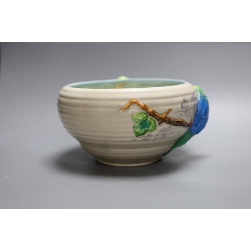 413 - A late Clarice Cliff bowl with perched parrot decoration, 12cm tall