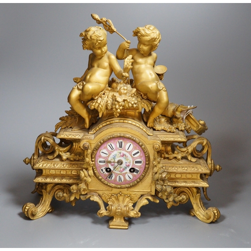 450 - A French putti mounted spelter mantel clock, 32cm