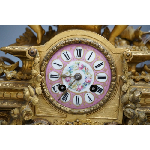 450 - A French putti mounted spelter mantel clock, 32cm