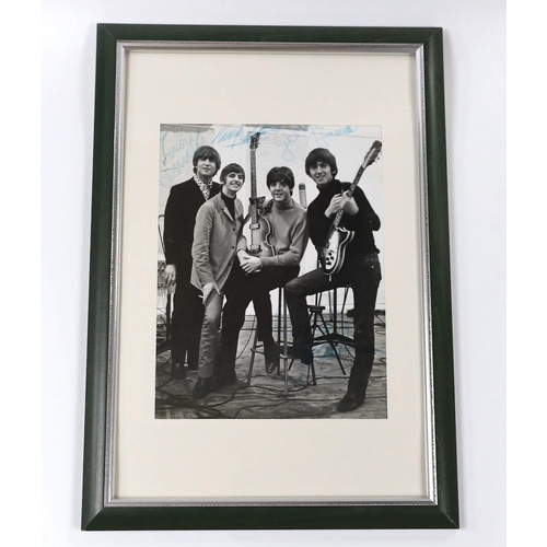 475 - A Beatles signed photo in glazed frame, 23 x 17cm, bearing the signature of all four members with ac... 